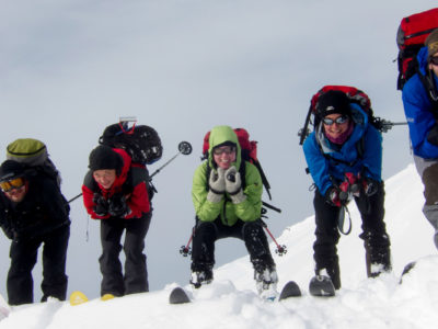 Fünf Skifahrer in Abfahrtshocke